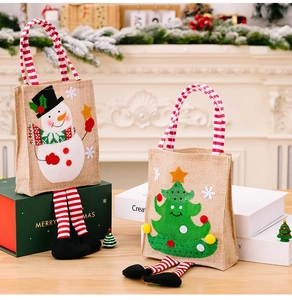 Detail of Christmas burlap gift bags with striped legs and snowman tree patterns