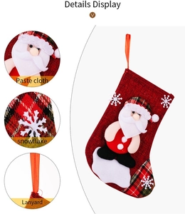 Detail view of red burlap Christmas stocking with Santa Claus applique and plaid trim
