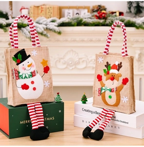 Detailed view of burlap Christmas bags with 3D snowman and reindeer applique designs