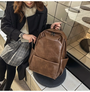 Brown vintage PU leather backpack styled with a minimalist preppy outfit for daily use