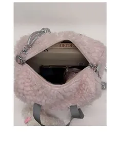 Detail view of large pink plush tote interior showing spacious storage and grey strap