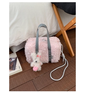 Pink fluffy plush handbag detail with woven gray handles and cute white bunny charm