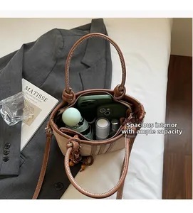 Macro shot of spacious canvas bucket bag interior showing organized daily essentials