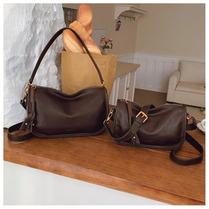 Detailed macro view of dark brown faux leather bag textures with elegant gold hardware accents