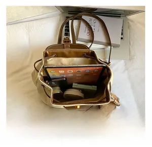 Top view of spacious interior of brown leather backpack showing tablet and phone capacity
