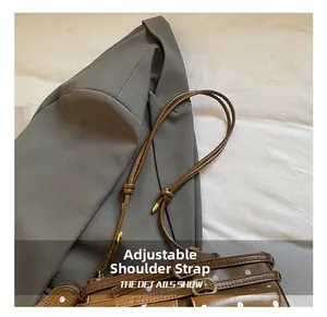 Detail shot of the adjustable shoulder strap hardware on the brown polka dot bag