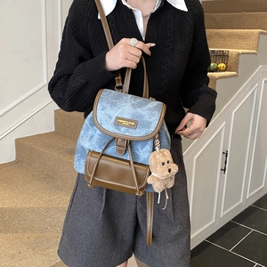 Vintage denim and brown leather patchwork backpack for women with cute bear charm detail