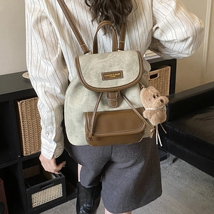 Vintage sage green and brown leather backpack with cute teddy bear charm for women