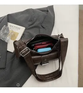Spacious interior of retro brown crossbody bag showing storage for phone and wallet