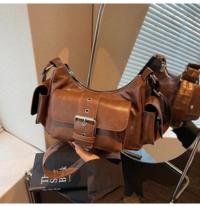 Detailed macro view of dark brown faux leather texture and metallic buckle on retro bag