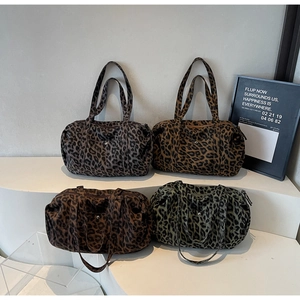 Detailed view of four leopard print tote bags with long handles and front snap pockets