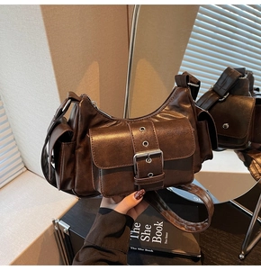 Detailed close-up of dark brown vintage motorcycle bag with silver metal eyelets and pockets