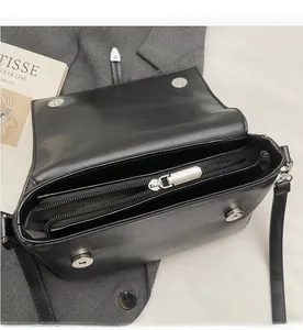 Detail of internal storage space with smooth silver zipper on black leather bag