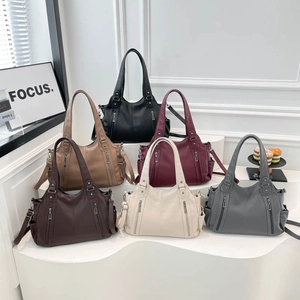 Group display of large leather tote bags in six colors including black, brown, and burgundy