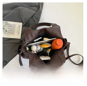 Detail shot of the spacious dark brown leather tote bag with ample storage capacity