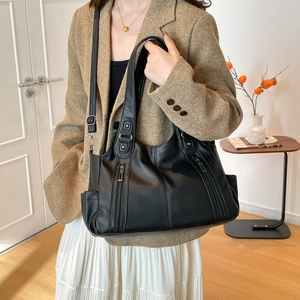 Classic black leather tote bag with pebble texture and dual vertical zipper pockets