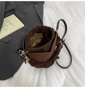 Close-up of the vintage brown frosted bucket bag with gold hardware and drawstring detail