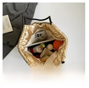 Internal view of a gold quilted tote bag showing large capacity for tablet and items