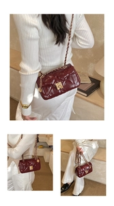 Detail view of burgundy quilted leather chain bag with golden square twist lock hardware