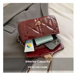 Detail view showing interior capacity for phone and cosmetics in wine red quilted bag
