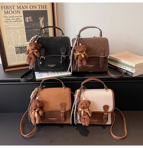 Macro detail of four vintage square crossbody bags with cute bear charms and ribbons