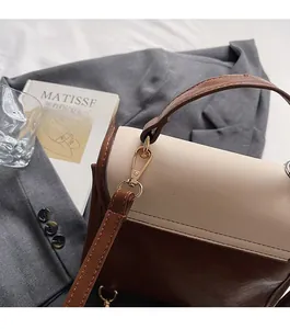 Close-up of premium gold hardware and dual-tone stitching on the retro crossbody bag