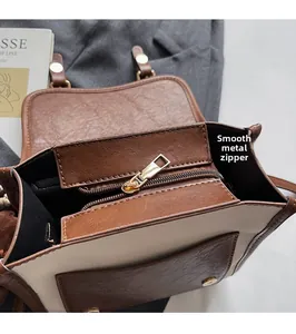 Detail view of smooth metal zipper and internal pocket of the vintage patchwork bag