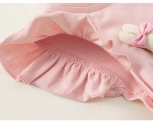 Detail of pink toddler shirt with soft knit fabric, ruffles, and cute 3D bunny ear accents