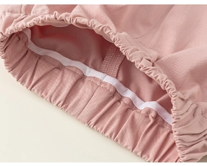 Dettaglio ravvicinato della vita elastica rosa con cuciture fini sui pantaloni da bambina