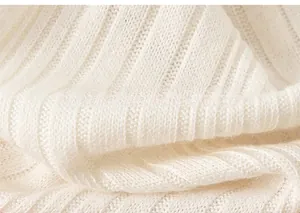 Close-up detail of soft white ribbed knit fabric texture on toddler girl shirt