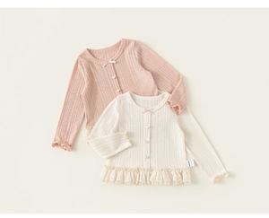Detail of sweet toddler knit cardigans with heart buttons and lace hem trim decorations