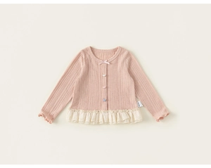 Detail of pink knit top featuring sweet heart-shaped buttons and lace trim hem