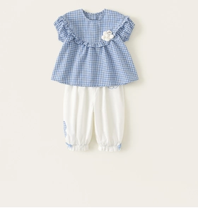 Detail of girls' blue plaid top with ruffle collar and white puffy pants set