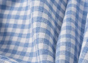 Close-up of soft blue gingham cotton fabric texture with breathable weaving detail