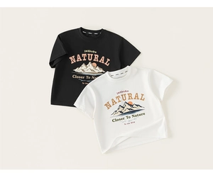 Detail of boys' cotton T-shirts featuring outdoor mountain prints and letter graphics