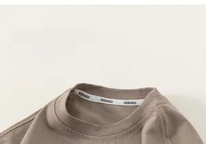 Detailed close-up of the round neckline and soft cotton fabric on this kids casual T-shirt