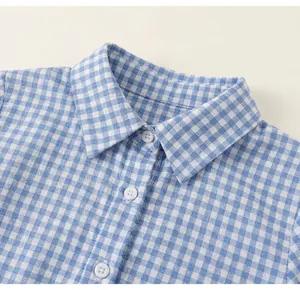 Detail of round neck and blue plaid cotton fabric with button closure for toddler girl set