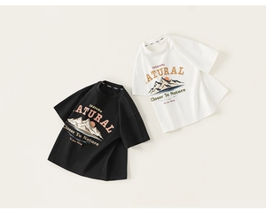 Detailed flat lay of boys cotton t-shirts in black and beige with outdoor nature prints