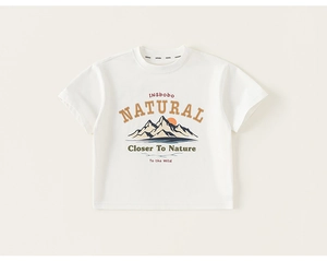 Detail of white cotton boy's t-shirt showing natural mountain and sunset graphic print