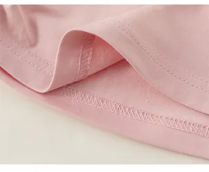 Close-up of pink knit T-shirt showing detailed hem stitching and double-needle craftsmanship