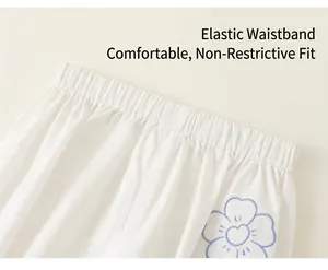 Close-up of girls cotton pants with elastic waistband and blue flower embroidery