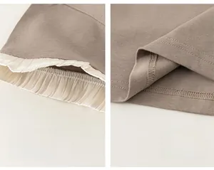 Detailed close-up of ruffled chiffon cuffs and even stitching on kids knit t-shirt