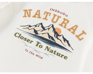 Close-up of white cotton t-shirt with vintage natural mountain print and orange typography