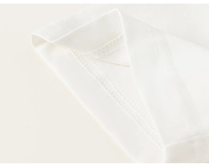 Close-up of double-needle stitching and neat hem seams on white cotton t-shirt