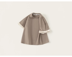 Detail of children's cotton t-shirt with pleated white ruffle trim on the sleeves
