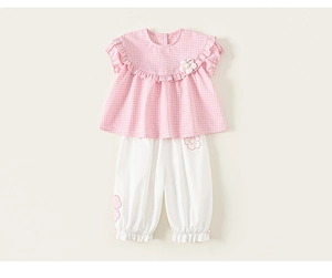 Detail of baby girl plaid shirt with floral applique and white ruffle lantern pants