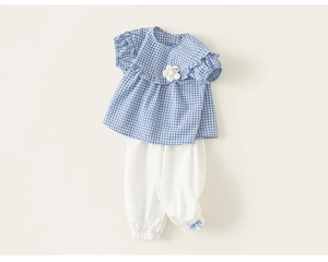 Detail of blue plaid baby girl summer set with ruffle collar and white flower accent