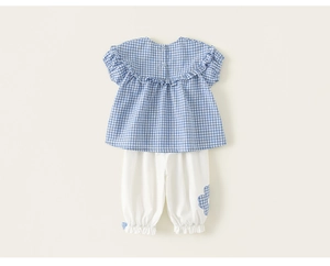 Detail view of baby girl plaid ruffle top with button back and floral matching pants