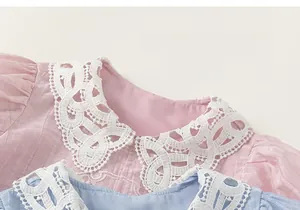 Close-up of pink and blue girls blouses with white floral lace collars in Chinese style