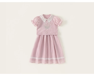 Detail of white lace petal collar and lily of the valley embroidery on pink cotton shirt